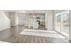 Spacious open-plan living area with gray wood floors, seamlessly connecting the kitchen and living spaces at 18029 Dandy Brush Ln, Parker, CO 80134