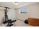 Functional bedroom with natural light, providing an exercise machine and a dresser at 10150 E Virginia Ave # 104, Denver, CO 80247
