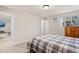 Bedroom features carpet, plaid-patterned bedspread, and a window air conditioning unit at 10150 E Virginia Ave # 104, Denver, CO 80247