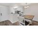 Bright dining area with modern fixtures, open to kitchen with stainless appliances at 10150 E Virginia Ave # 104, Denver, CO 80247