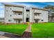 Inviting multi-Gathering home showcasing well-manicured lawn and multiple balconies on a sunny day at 10150 E Virginia Ave # 104, Denver, CO 80247