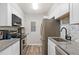 Modern kitchen featuring stainless steel appliances, granite countertops, and stylish backsplash at 10150 E Virginia Ave # 104, Denver, CO 80247