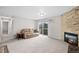 Spacious living room featuring a fireplace, sliding glass doors, and comfortable seating at 10150 E Virginia Ave # 104, Denver, CO 80247