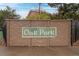 Stone wall with a green sign that reads: Oak Park, and black metal fence with greenery at 10150 E Virginia Ave # 104, Denver, CO 80247