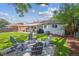 Lush backyard featuring a patio, Adirondack chairs and well-maintained lawn at 1888 S Filbert Ct, Denver, CO 80222