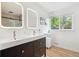 Modern bathroom with double vanity, sleek lighting and contemporary fixtures and finishes at 1888 S Filbert Ct, Denver, CO 80222