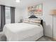Bedroom featuring soft carpet, natural light, and decorative wall art at 1888 S Filbert Ct, Denver, CO 80222