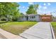 Well-maintained home featuring a lush lawn, covered parking, and a concrete driveway at 1888 S Filbert Ct, Denver, CO 80222