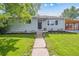 Charming single-story home with manicured lawn and inviting walkway leading to the front door at 1888 S Filbert Ct, Denver, CO 80222