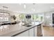 Bright kitchen with an island overlooking a dining area and living room at 1888 S Filbert Ct, Denver, CO 80222