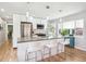 Contemporary kitchen featuring a central island with bar stools, stainless appliances, and backyard view at 1888 S Filbert Ct, Denver, CO 80222