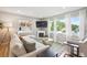 Bright living room with hardwood floors, a fireplace, and lots of natural light from the large windows at 1888 S Filbert Ct, Denver, CO 80222
