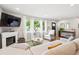 Cozy living area with a fireplace, large sectional sofa, and bright windows at 1888 S Filbert Ct, Denver, CO 80222