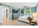 Bright main bedroom with modern gray dresser, stylish fan and natural light streaming through the windows at 1888 S Filbert Ct, Denver, CO 80222