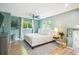 Cozy main bedroom featuring large windows, ceiling fan and stylish decor at 1888 S Filbert Ct, Denver, CO 80222