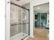 Modern walk-in shower featuring glass doors and contemporary fixtures and finishes, across from main bedroom at 1888 S Filbert Ct, Denver, CO 80222