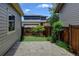 Landscaped backyard area with stone pavers, artificial grass, and a privacy fence at 5080 Uinta St, Denver, CO 80238