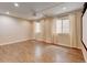 Spacious basement featuring wood-look floors, recessed lighting, and window-covered with white curtains at 5080 Uinta St, Denver, CO 80238