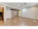 Finished basement with wood-look floors, recessed lighting, and sliding barn doors at 5080 Uinta St, Denver, CO 80238