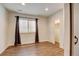 Cozy bedroom featuring wood-look floors, closet, a window with blinds and dark curtains at 5080 Uinta St, Denver, CO 80238