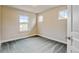 Bedroom with neutral walls, carpet floors, white trim, and a door and large windows at 5080 Uinta St, Denver, CO 80238