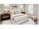 Bedroom featuring a comfortable bed, neutral walls, and a bright window with white shutters at 5080 Uinta St, Denver, CO 80238