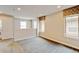 Bonus room with carpet floors, windows with decorative shades, white trim and a laundry area at 5080 Uinta St, Denver, CO 80238