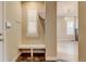 Welcoming entryway with built-in bench, white trim, and tiled flooring detail at 5080 Uinta St, Denver, CO 80238
