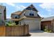 Charming two-story home with a well-maintained lawn, two-car garage, and inviting curb appeal at 5080 Uinta St, Denver, CO 80238