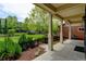 Covered front porch with sturdy pillars and an attractive view of the landscaped front yard at 5080 Uinta St, Denver, CO 80238