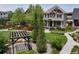 Beautiful front yard features manicured lawn, landscaping, and a charming pergola with stone garden at 5080 Uinta St, Denver, CO 80238