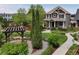 Beautiful front yard features manicured lawn, landscaping, a charming pergola, and walking path at 5080 Uinta St, Denver, CO 80238