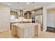 Gourmet kitchen with custom cabinets, a center island, and stainless steel appliances at 5080 Uinta St, Denver, CO 80238