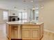 Kitchen island featuring granite countertop, stainless steel dishwasher, and light wood cabinets at 5080 Uinta St, Denver, CO 80238