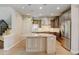 Open kitchen layout with granite island, stainless appliances, and hardwood flooring at 5080 Uinta St, Denver, CO 80238