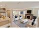 Open-concept living room featuring modern furniture, a fireplace, and plenty of natural light at 5080 Uinta St, Denver, CO 80238
