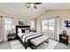 Comfortable main bedroom featuring an upholstered bed frame, vaulted ceilings, and lots of natural light at 5080 Uinta St, Denver, CO 80238