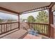 View of the outdoor balcony featuring a wood floor and railing with a view of trees at 17652 E Loyola Dr # 2032R, Aurora, CO 80013