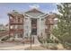Condo building with balconies, green landscaping, and neutral gray siding, exuding charm and comfort at 17652 E Loyola Dr # 2032R, Aurora, CO 80013