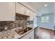 Updated kitchen featuring granite countertops, stainless appliances, and a bright, inviting atmosphere at 17652 E Loyola Dr # 2032R, Aurora, CO 80013