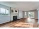 Bright living room featuring a stone fireplace, wood floors, and access to a private balcony at 17652 E Loyola Dr # 2032R, Aurora, CO 80013