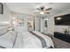 Bright bedroom with view to en suite, walk-in closet, ceiling fan, and plush carpeting at 646 S Joplin St, Aurora, CO 80017