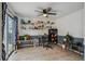 Bright room with a ceiling fan, and neutral colors accented by built-in shelves along the back wall at 646 S Joplin St, Aurora, CO 80017