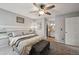 Comfortable bedroom with a ceiling fan, soft carpeting, and a doorway leading to the bathroom at 646 S Joplin St, Aurora, CO 80017