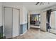 Hallway featuring tile flooring, an open doorway to the living room, and access to the patio at 646 S Joplin St, Aurora, CO 80017