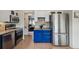 Charming kitchen featuring stainless steel appliances, blue cabinetry, and modern countertops at 646 S Joplin St, Aurora, CO 80017