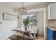 Bright kitchen nook with a wooden table, bench seating, and a modern light fixture at 646 S Joplin St, Aurora, CO 80017