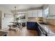 Well-lit eat-in kitchen with stainless steel appliances, a cozy bench, and stylish overhead lighting at 646 S Joplin St, Aurora, CO 80017