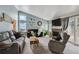 Bright living room featuring vaulted ceilings, a brick fireplace, and plenty of natural light at 646 S Joplin St, Aurora, CO 80017