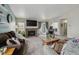 Spacious living room with a brick fireplace, plush seating, and access to the outdoors at 646 S Joplin St, Aurora, CO 80017